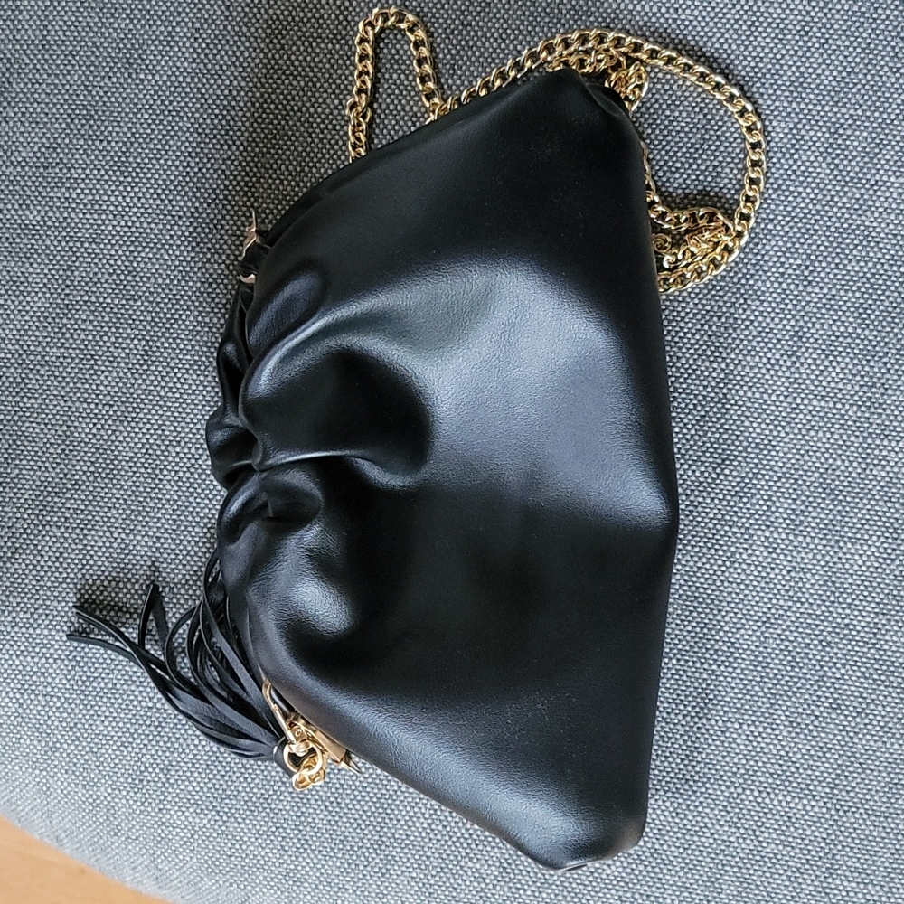 Vegan leather clutch with removable gold chain strap.